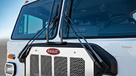 Peterbilt Model 520 Vocational White Truck Front End Closeup in Dirt Mud Flats Background - Thumbnail